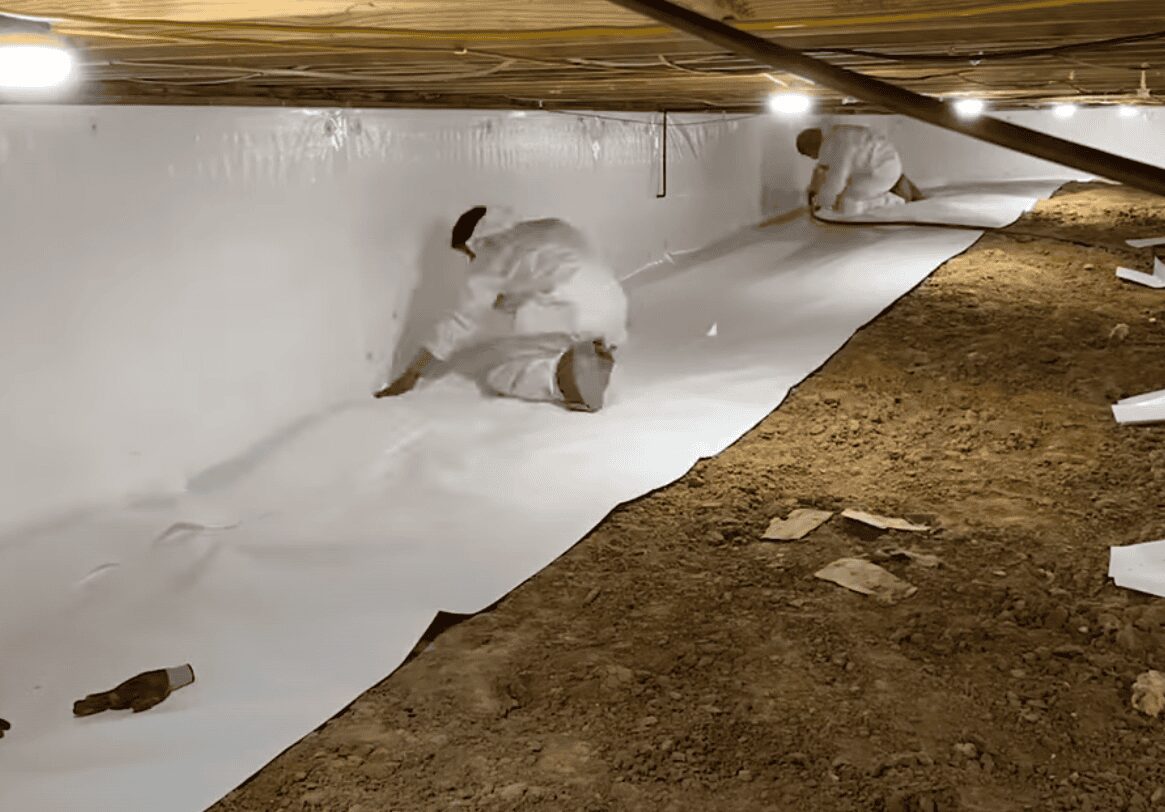 Crawlspace Encapsulation in Progress Team actively installing crawlspace encapsulation.